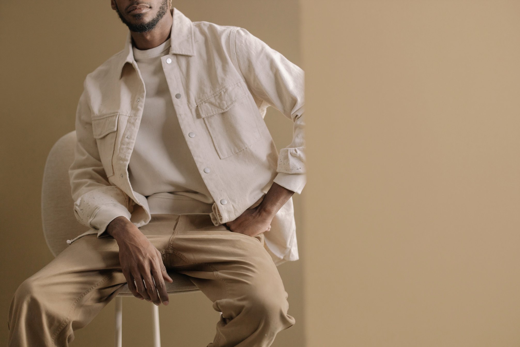 Person in Beige Jacket Sitting on a Chair